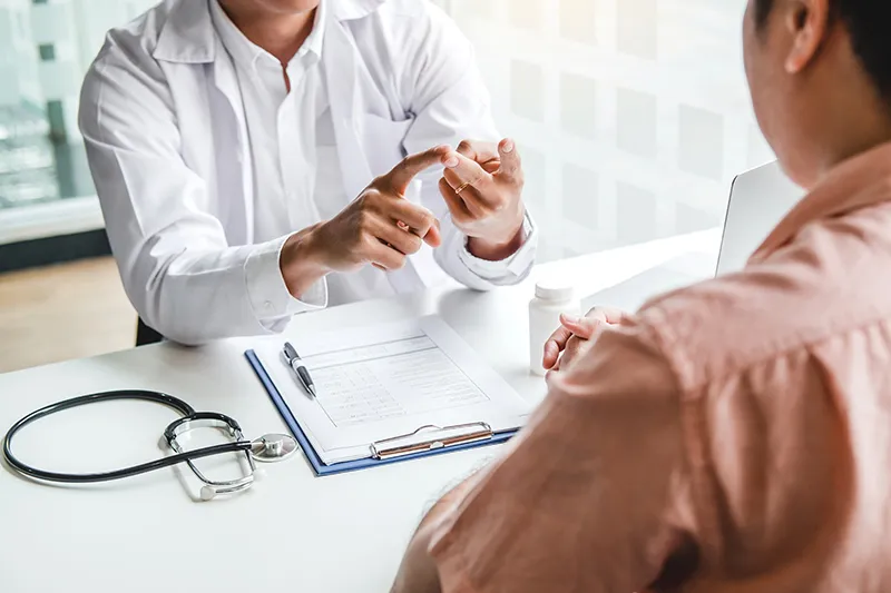 Doctor explaining to a male patient the results of his colonoscopy.
